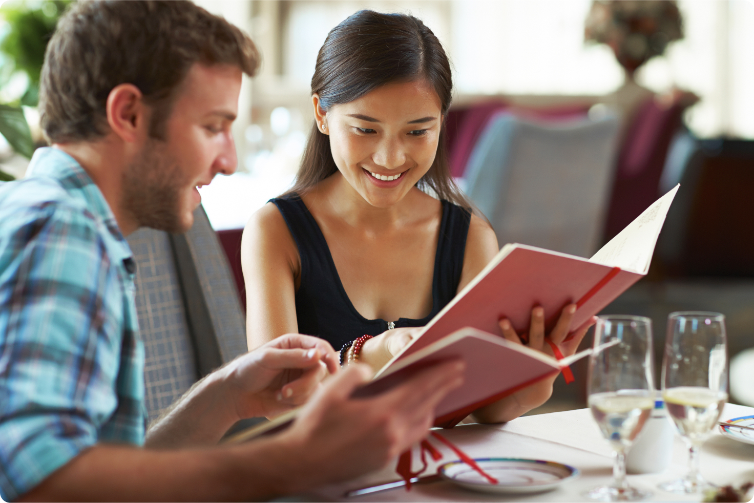 Two people choosing from a menu