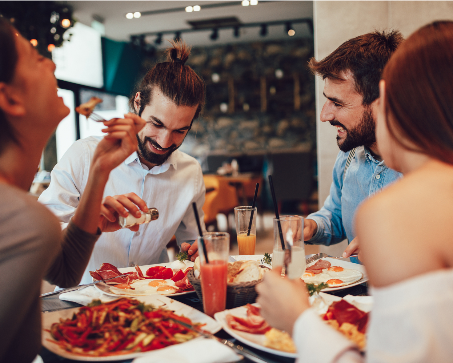Fiends eating a meal together and laughing